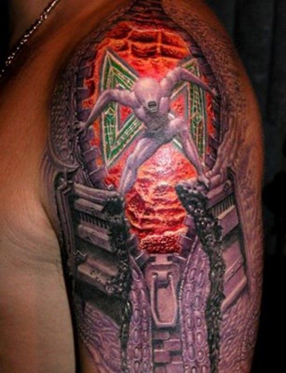 Crazy alien tattoo on the arm
