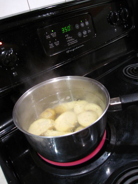 Potatoes Boiling On A Black Stove