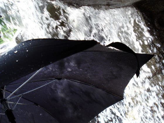 The Unbreakable Umbrella Getting Soaked Under A Water Fall