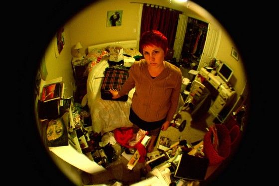 a woman in a very messy room