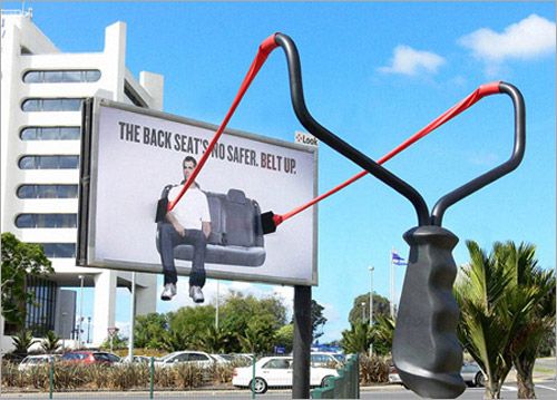 World's Most Creative Advertisements and Billboards 14 man sitting in a slingshot on a billboard