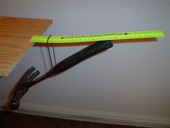 Hammer and ruler hanging off a table optical illusion