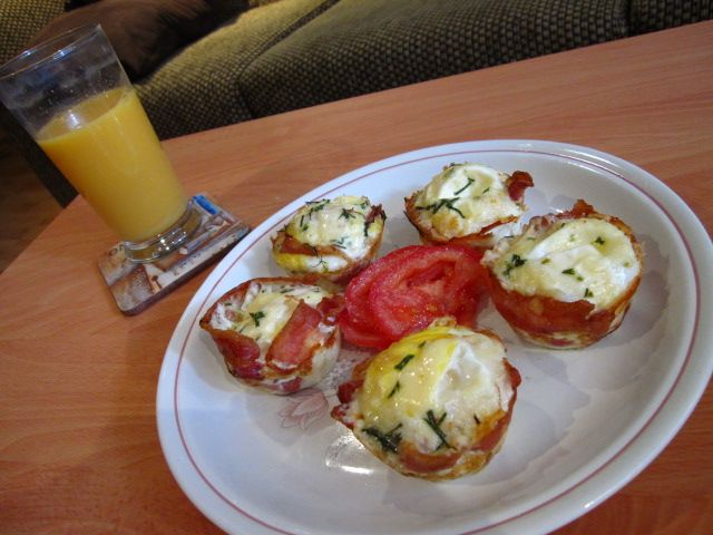 Orange Juice and a plate with eggs wrapped in bacon