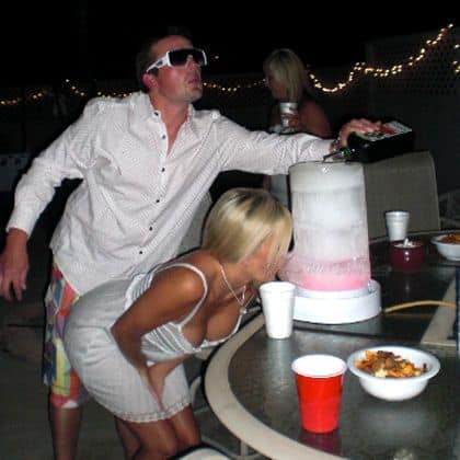 Guy pours drink in ice luge for hot girl