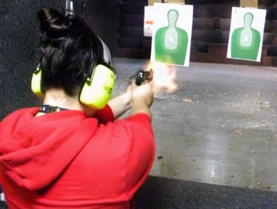 Girl Firing A Pistol With Muzzle Flash