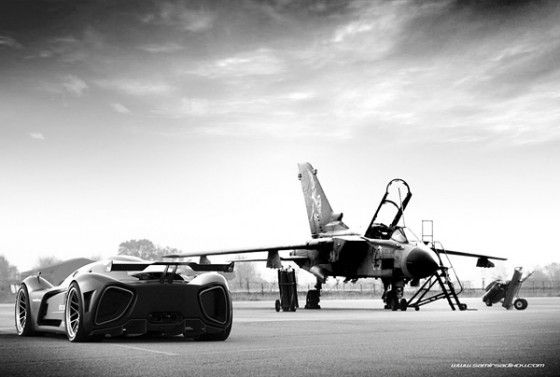 Race car at the track with a jet