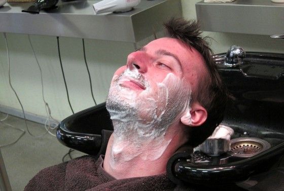 Chad smiling while getting a straight razor shave