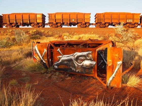 rusted car near train tracks