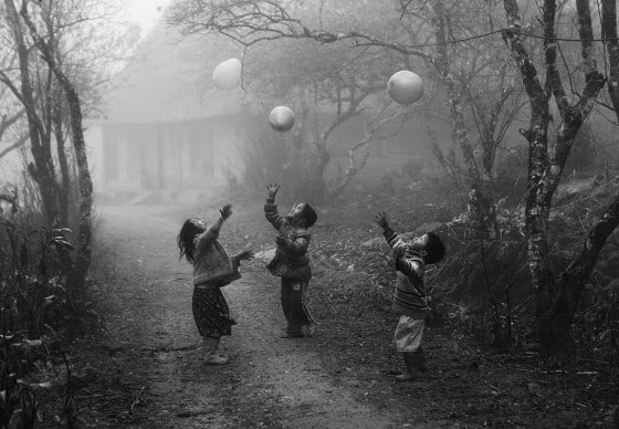 H'mong children playing in fog with balloons