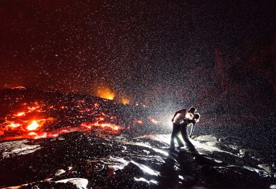 Man and woman kiss close to Lava