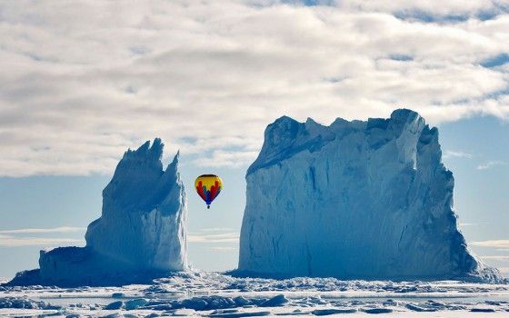 Photo of hot air balloon by glaciers
