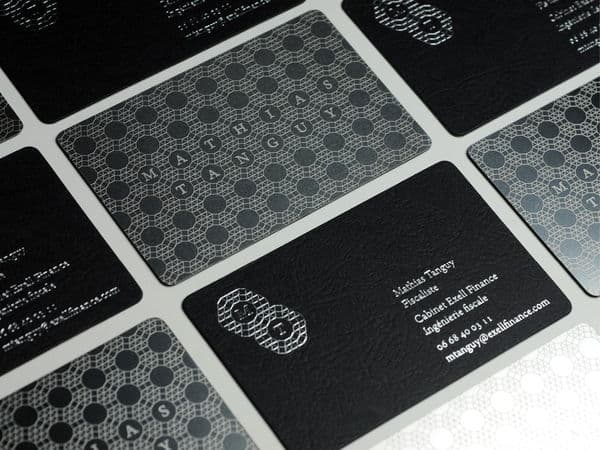 silver and black stamped business cards