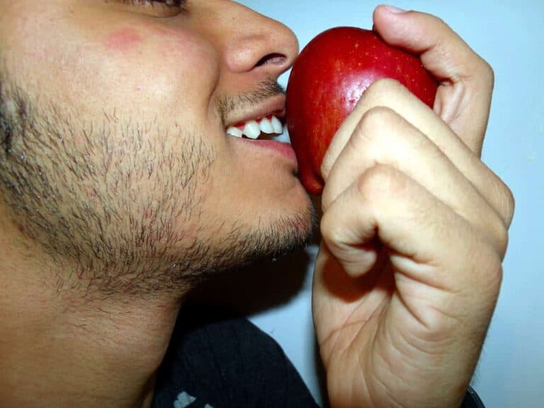 smiling man eating apples