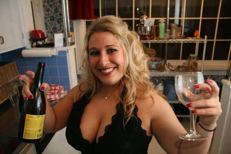woman holding empty wine glass