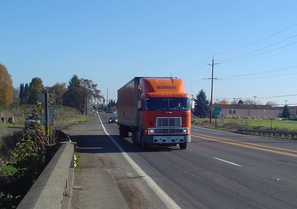 long haul truck driving on road