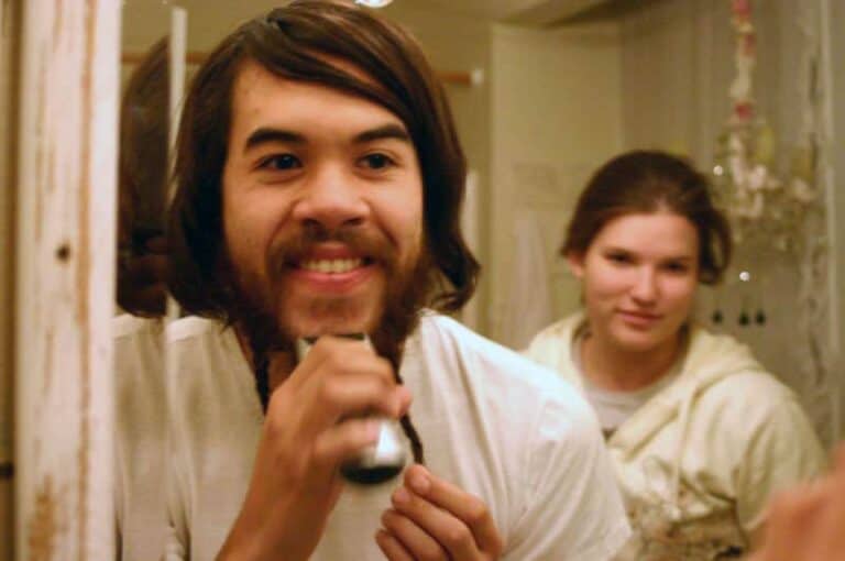man shaving face electric razor