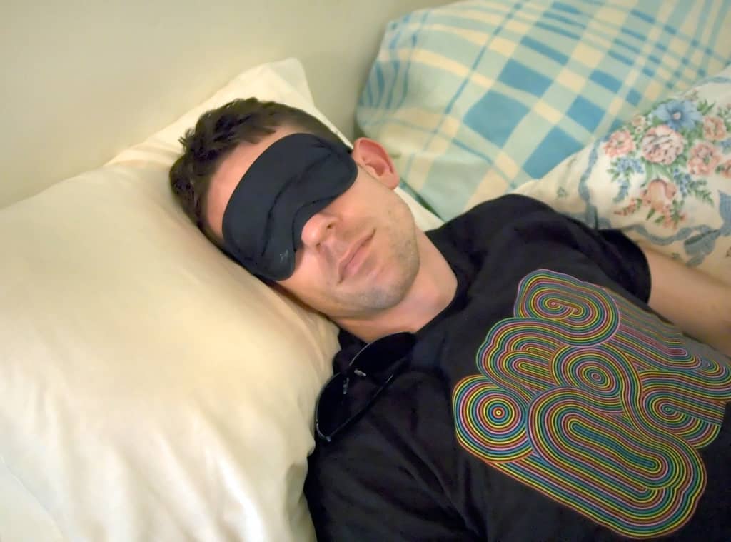 man wearing sleep mask