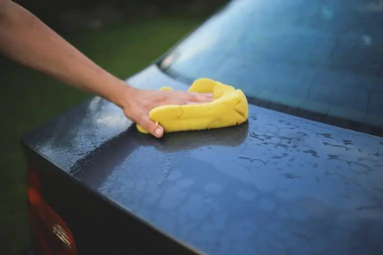 man cleaning car