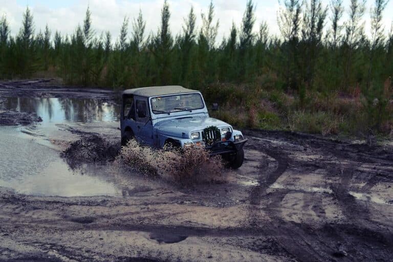 jeep driving through mud