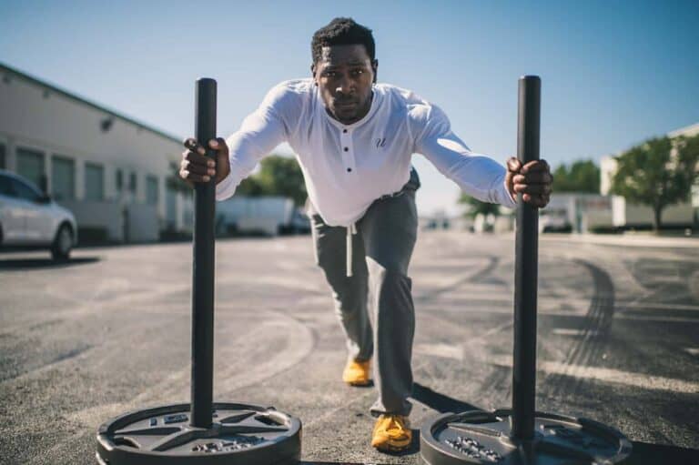 man pushing weights
