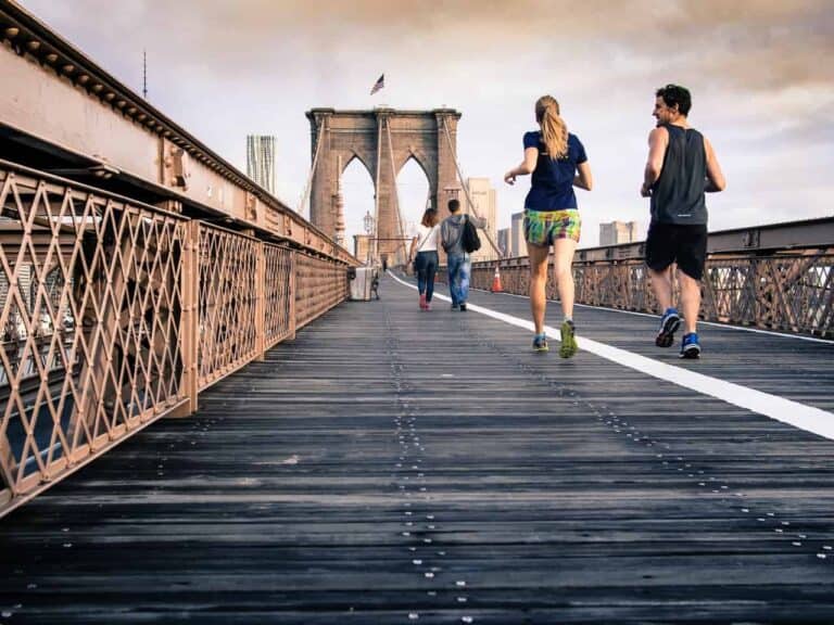 people jogging on bridge