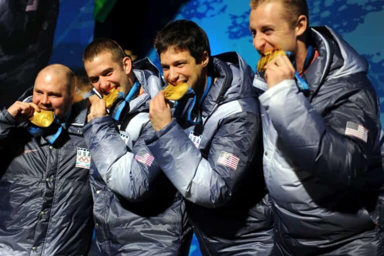 people biting medal
