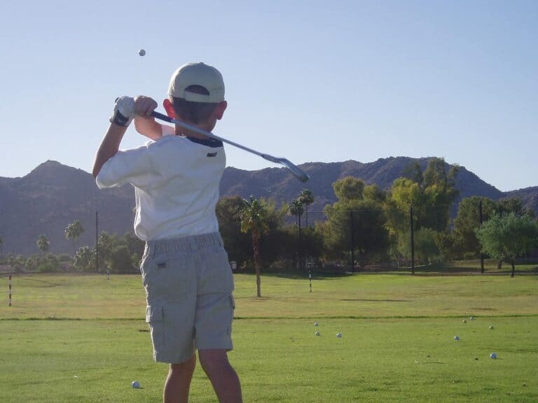 small child playing golf
