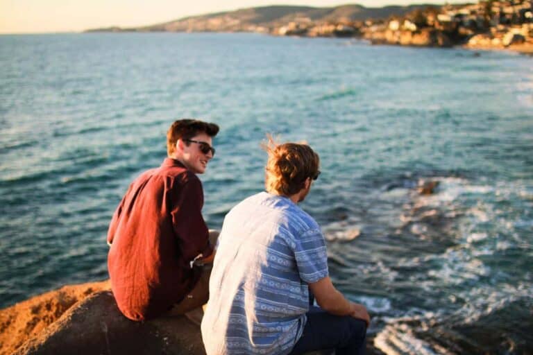 dudes hanging out near ocean