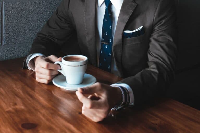 guy in suit drinking coffee