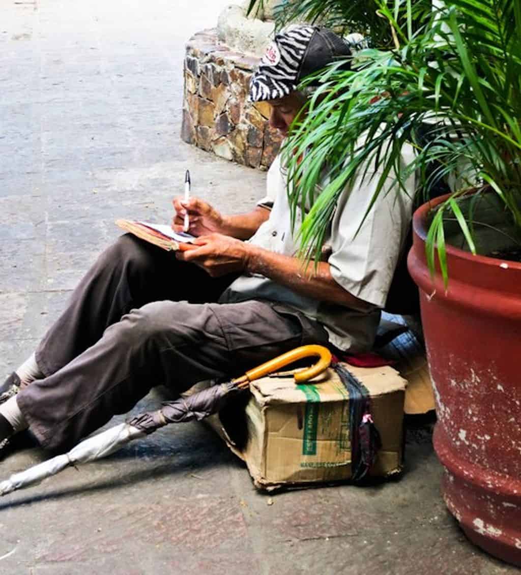 homeless man writing