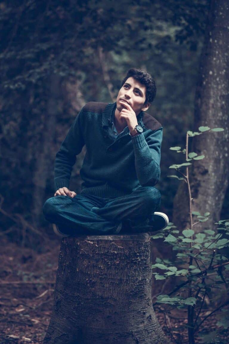 man pondering on stump