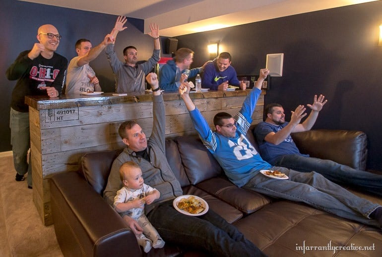 men cheering tv