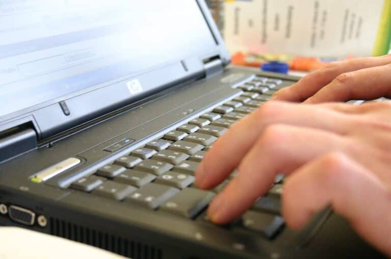person typing keyboard