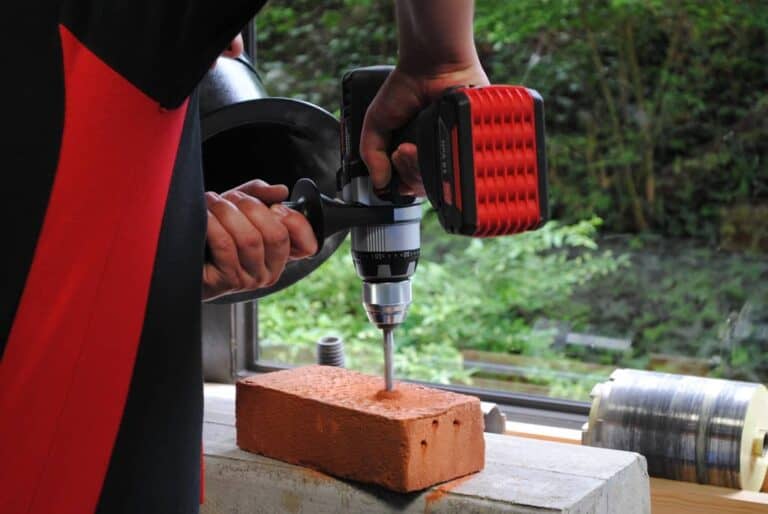 person using cordless drill
