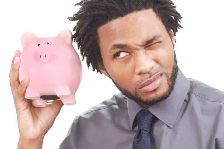 stockvault man shaking a piggy bank127892
