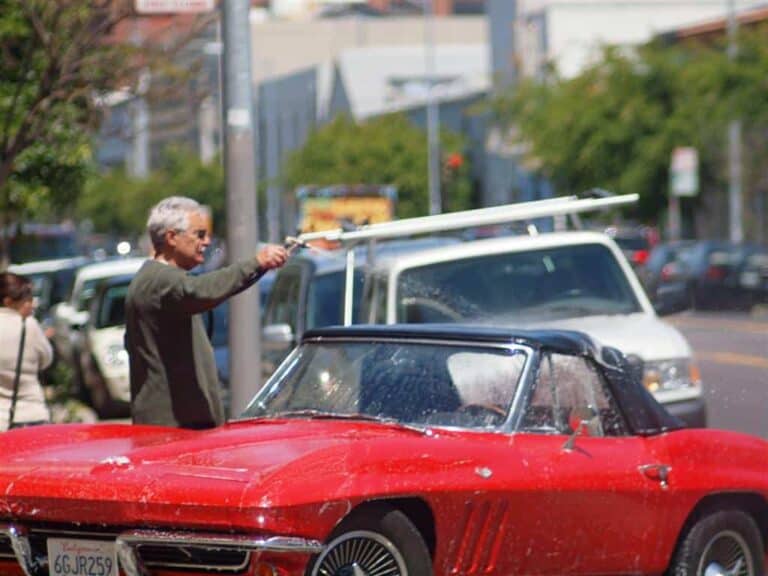 man washing car
