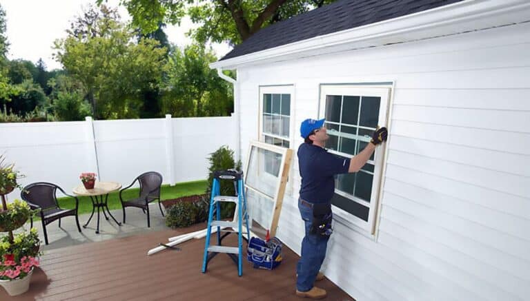 man replacing window