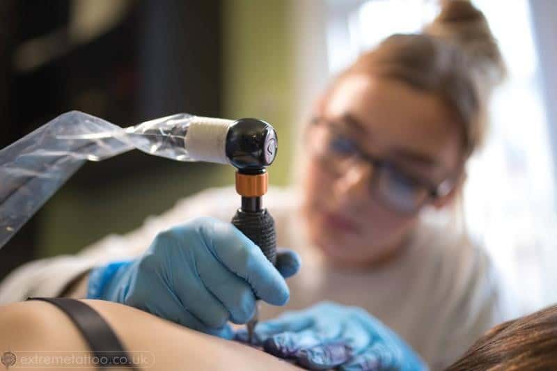 tattoo artist working