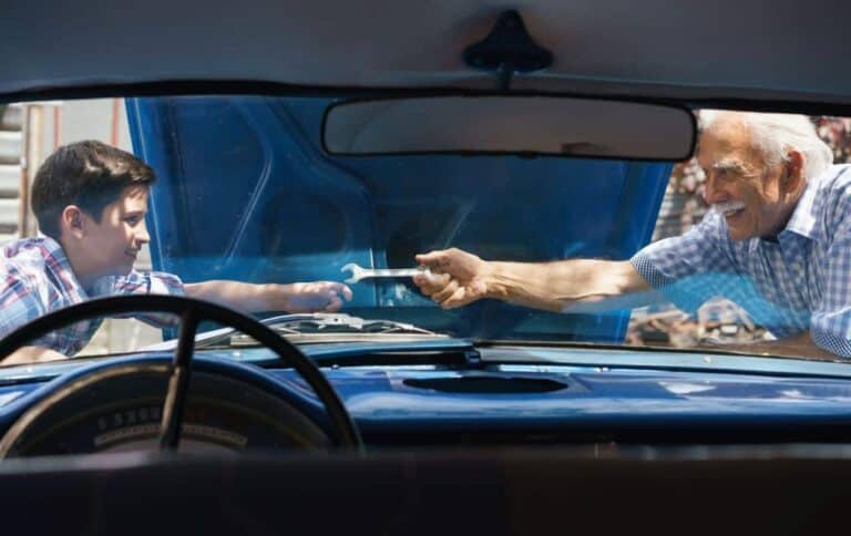 old man grandpa fixing car engine with boy PKLBJCZ