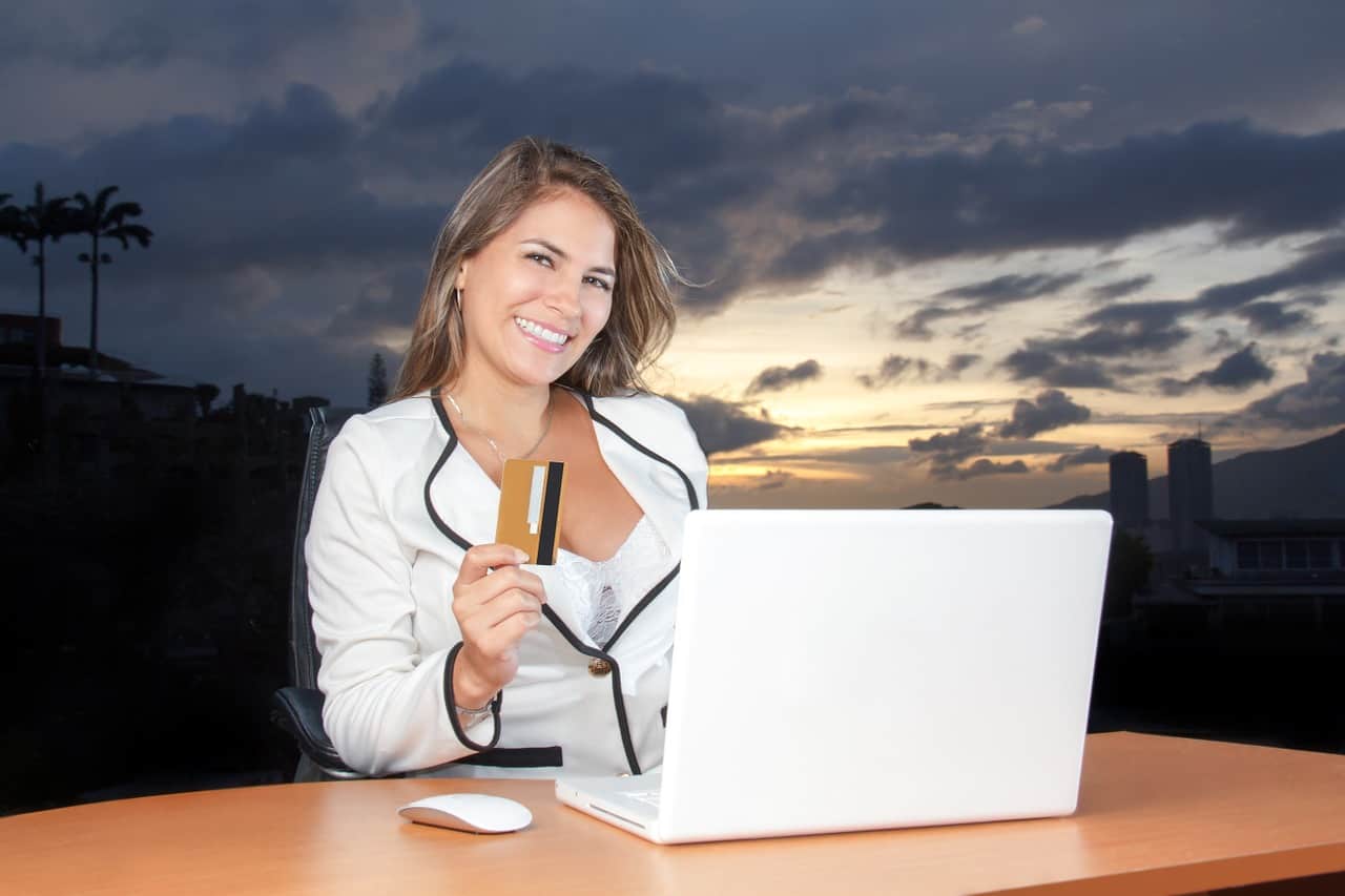 woman smiling with credit card