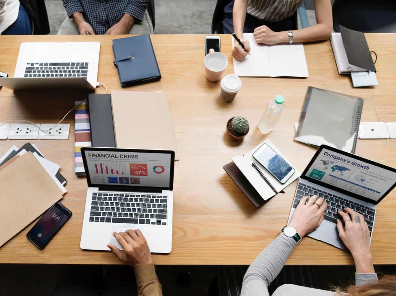 Ready to Start a Web Hosting Company? Following These 5 Steps 2 people desks working