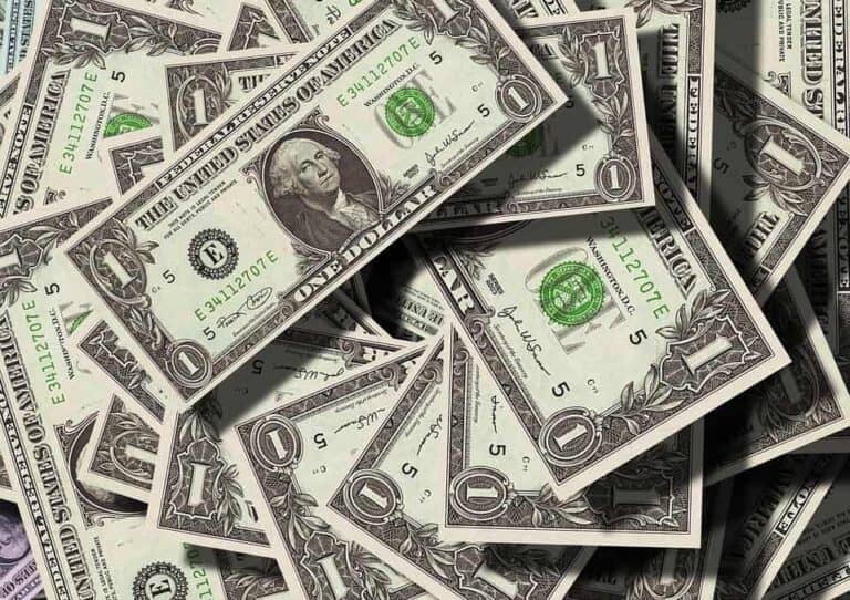 dollar bills piled