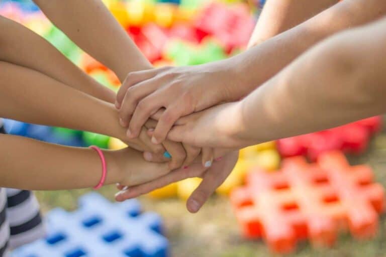group clasping hands