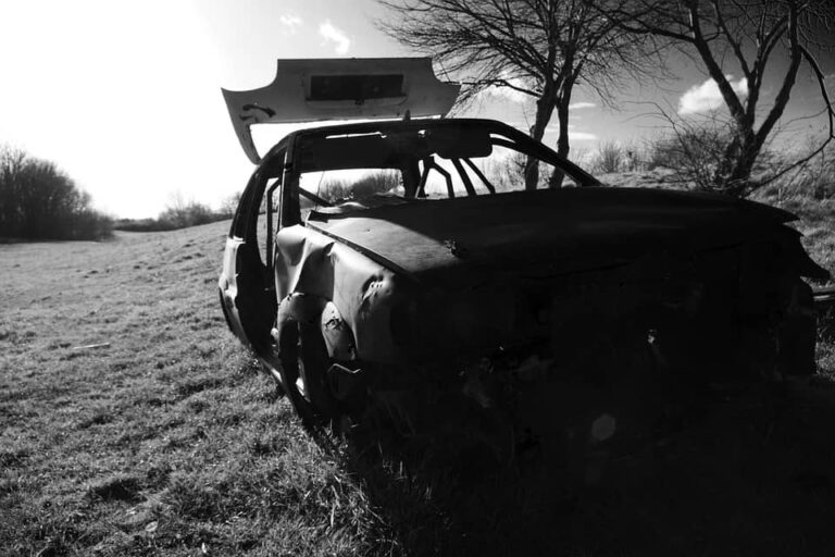 trashed car field
