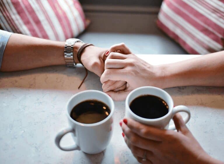 holding hands drinking coffee