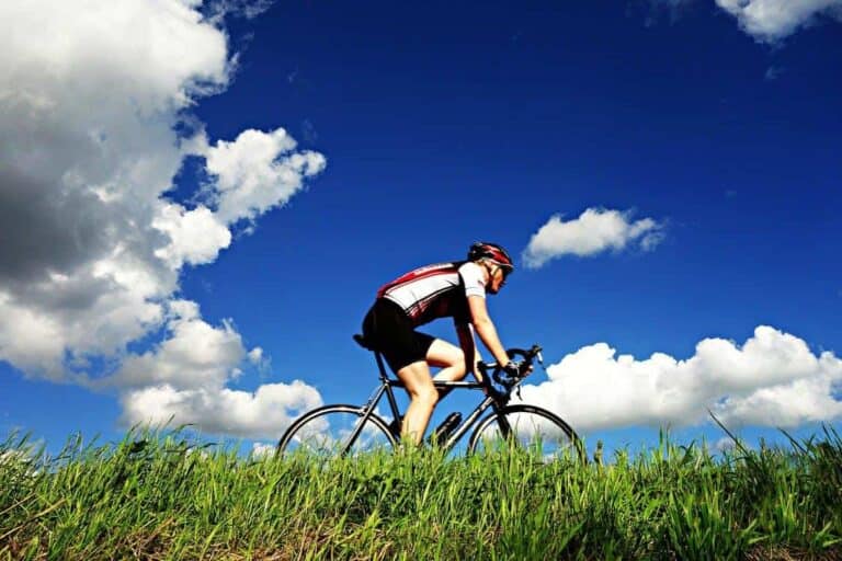 person cycling blue sky