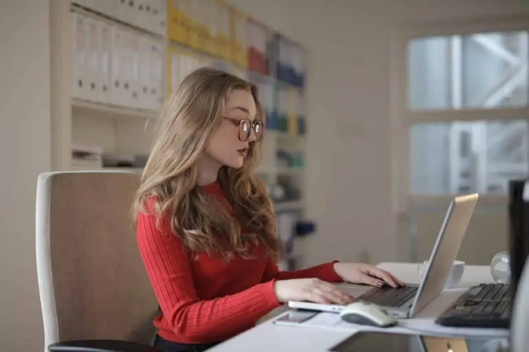 woman in red long sleeve shirt wearing eyeglasses using 3791130