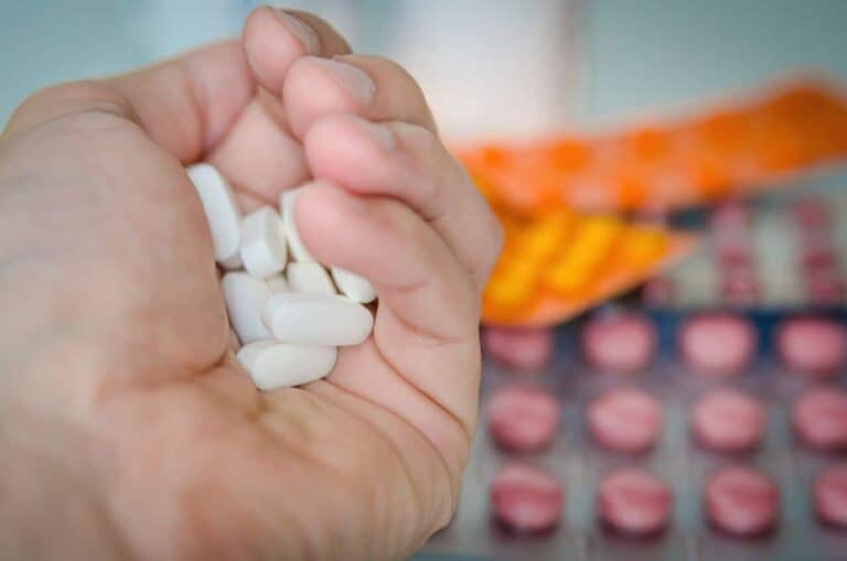 man holding pills