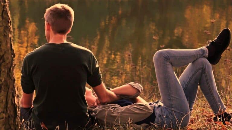 two people laying outside