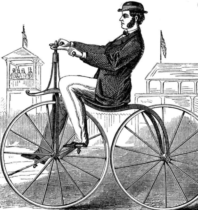 man riding penny farthing